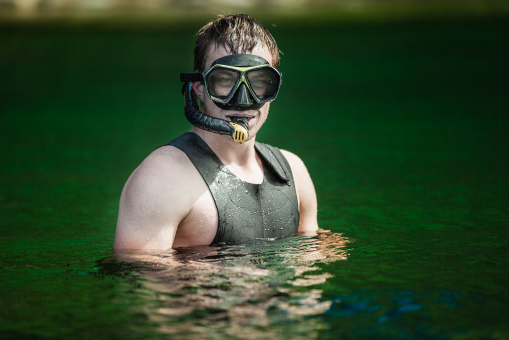 funny-young-adult-snorkeling-in-a-river-PFGFQF3Low-